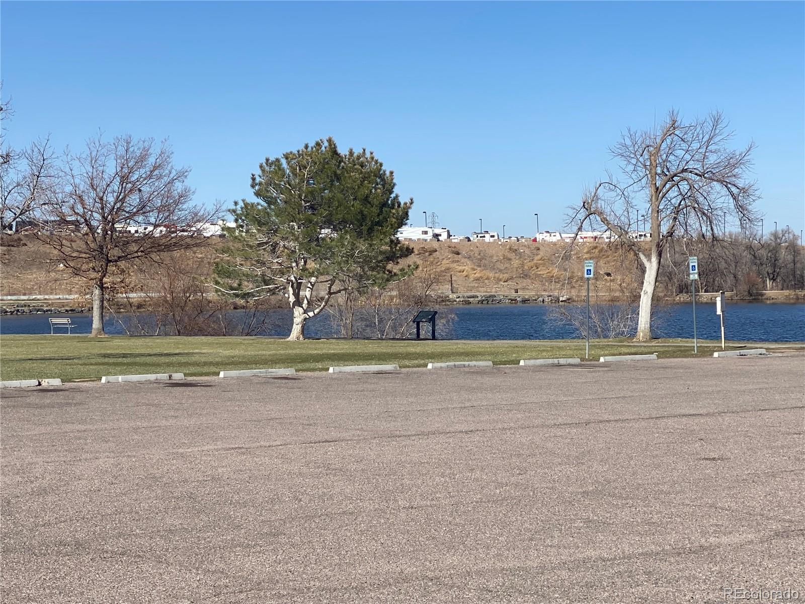 4671 South Decatur Street, Unit 232 Englewood, CO 80110 - Photo 32 of 32 a view of a house with a yard and a large tree