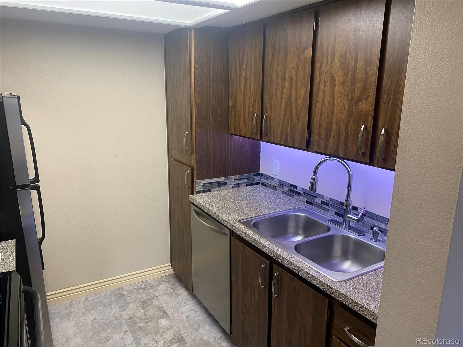 4671 South Decatur Street, Unit 232 Englewood, CO 80110 - Photo 8 of 32 a bathroom with a sink and a mirror