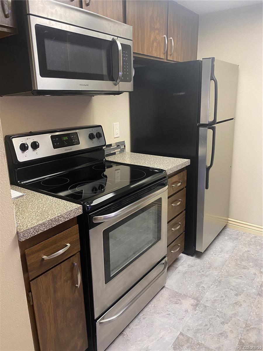 4671 South Decatur Street, Unit 232 Englewood, CO 80110 - Photo 9 of 32 a stove top oven sitting inside of a kitchen