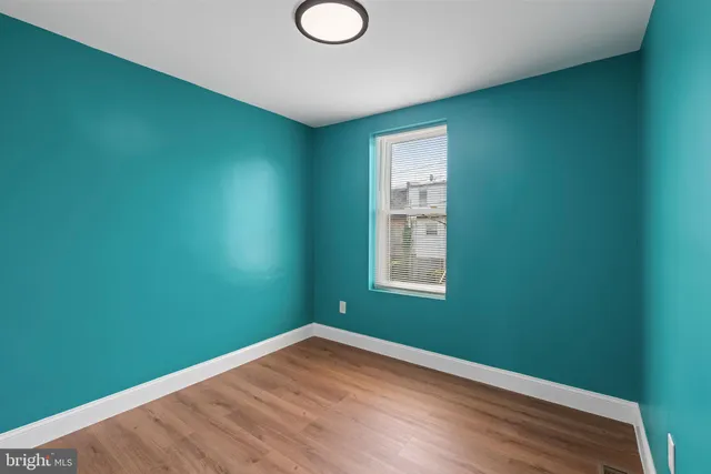 a view of a room with wooden floor and windows