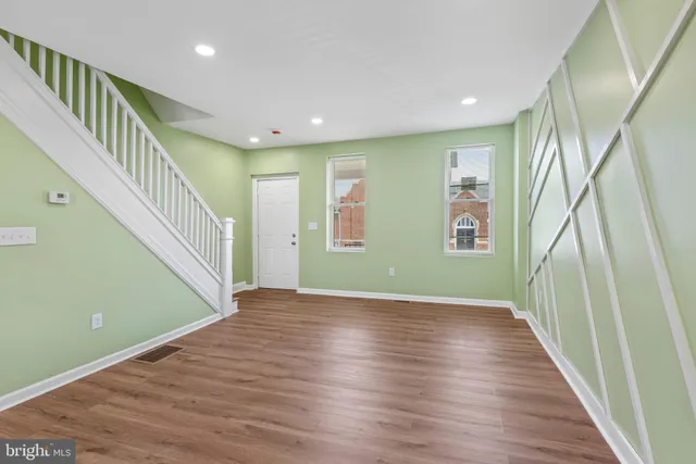 a view of an entryway with wooden floor