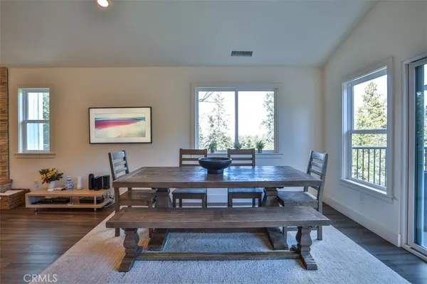 a view of a workspace with furniture window and wooden floor