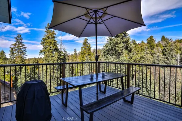 a view of a balcony with chairs and wooden floor