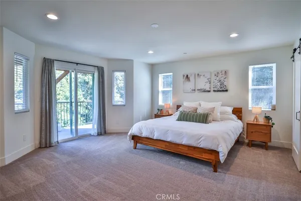 a spacious bedroom with a large bed and a large window