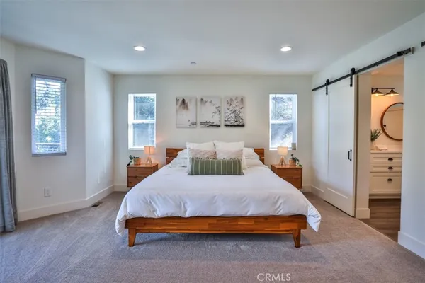 a bedroom with a bed and closet with window