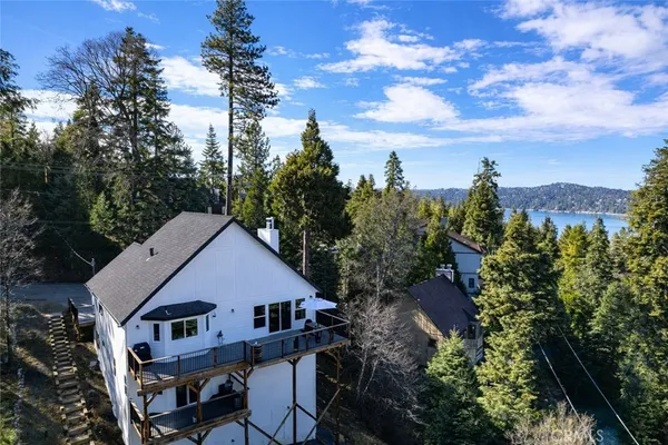 a aerial view of a house with a yard and trees
