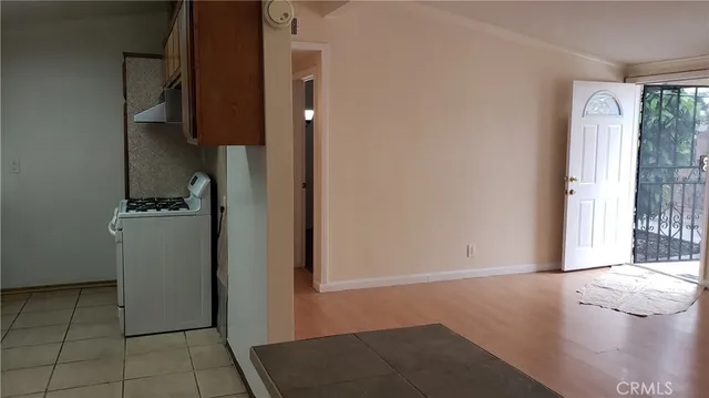 a view of hallway with walk in closet and a window