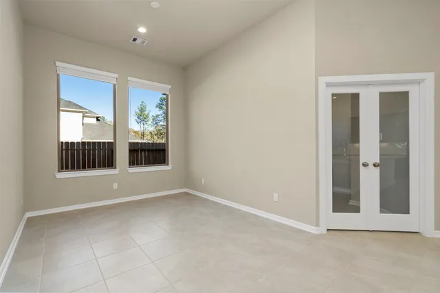 an empty room with windows and entrance