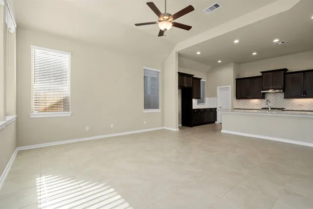a view of kitchen with refrigerator and window