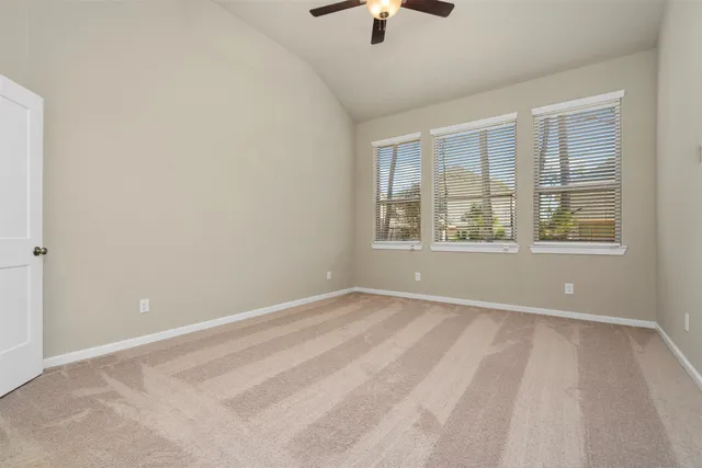 an empty room with windows and closet