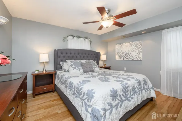 a bedroom with a large bed and a chandelier