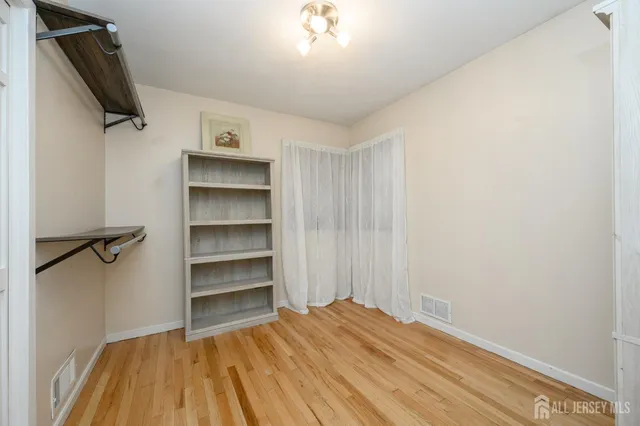 a bedroom with a bed and a flat tv screen