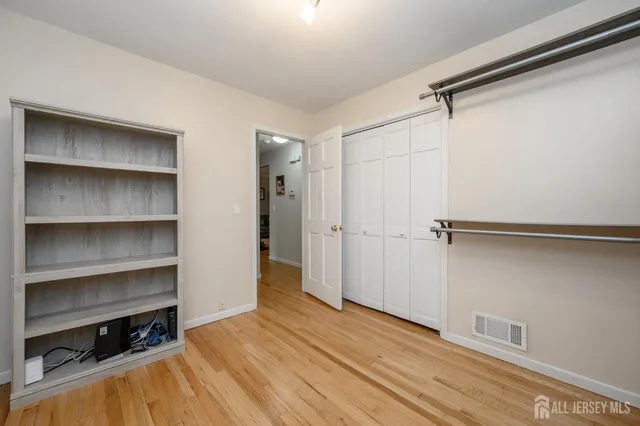 a view of walk in closet with empty racks