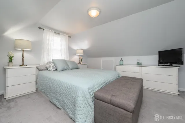 a bedroom with a bed and a night stand