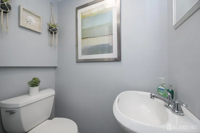 a white toilet sitting next to a bathroom sink