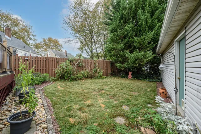 a view of a deck with wooden floor barbeque oven and trees