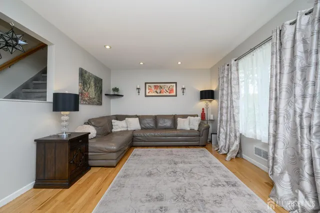 a view of a living room filled with furniture and a rug