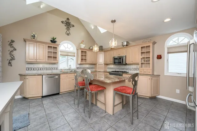 a kitchen with a sink a counter top space and stainless steel appliances