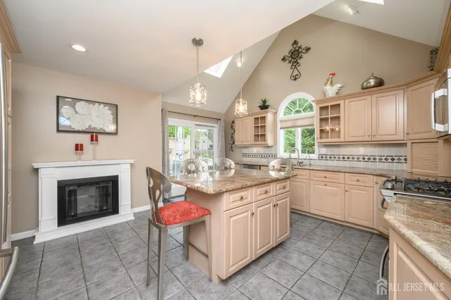 a open kitchen with stainless steel appliances granite countertop a stove and cabinets
