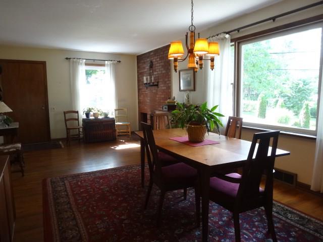 Large open entry and dining room with fireplace.