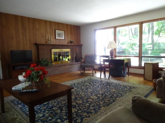Fantastic sun drenched family room with fireplace and view of the private patio.