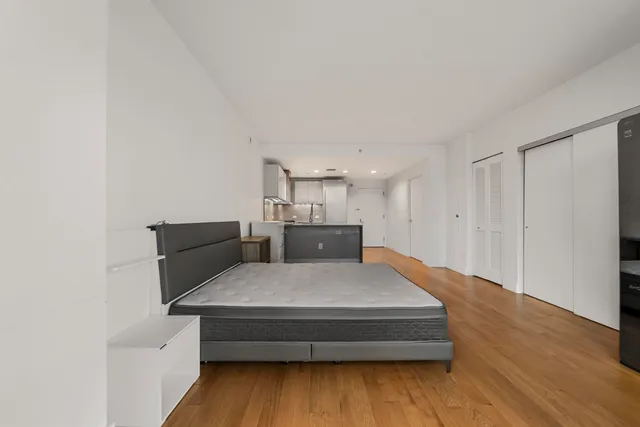 a living room with furniture and kitchen