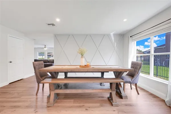 a view of a dining room with furniture window and wooden floor