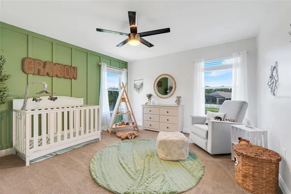 a bedroom with furniture and a large window