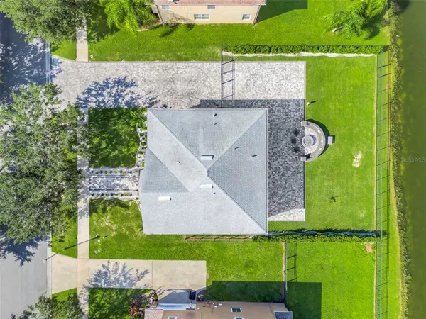 an aerial view of a house having a yard