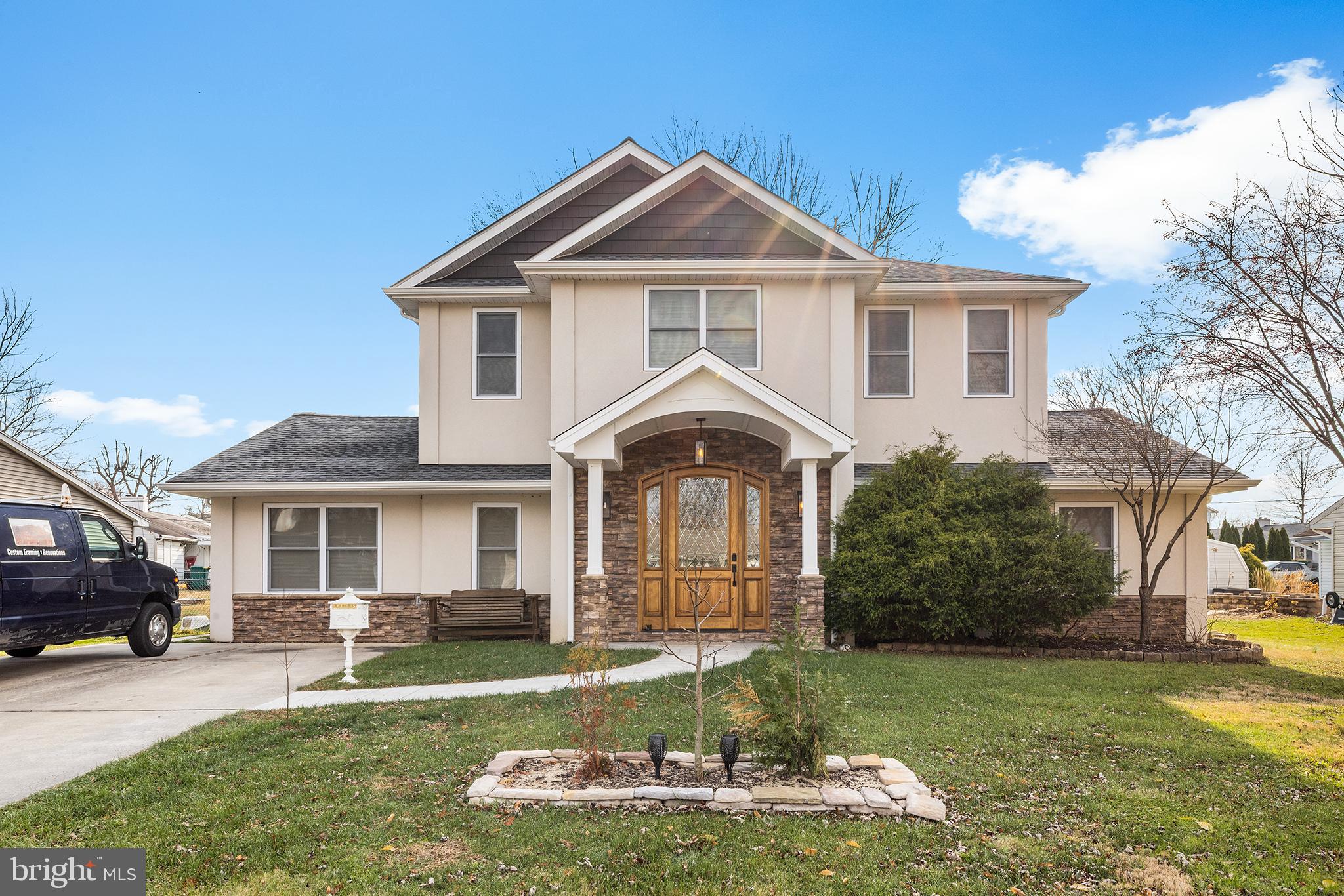 a front view of a house with a garden and porch
