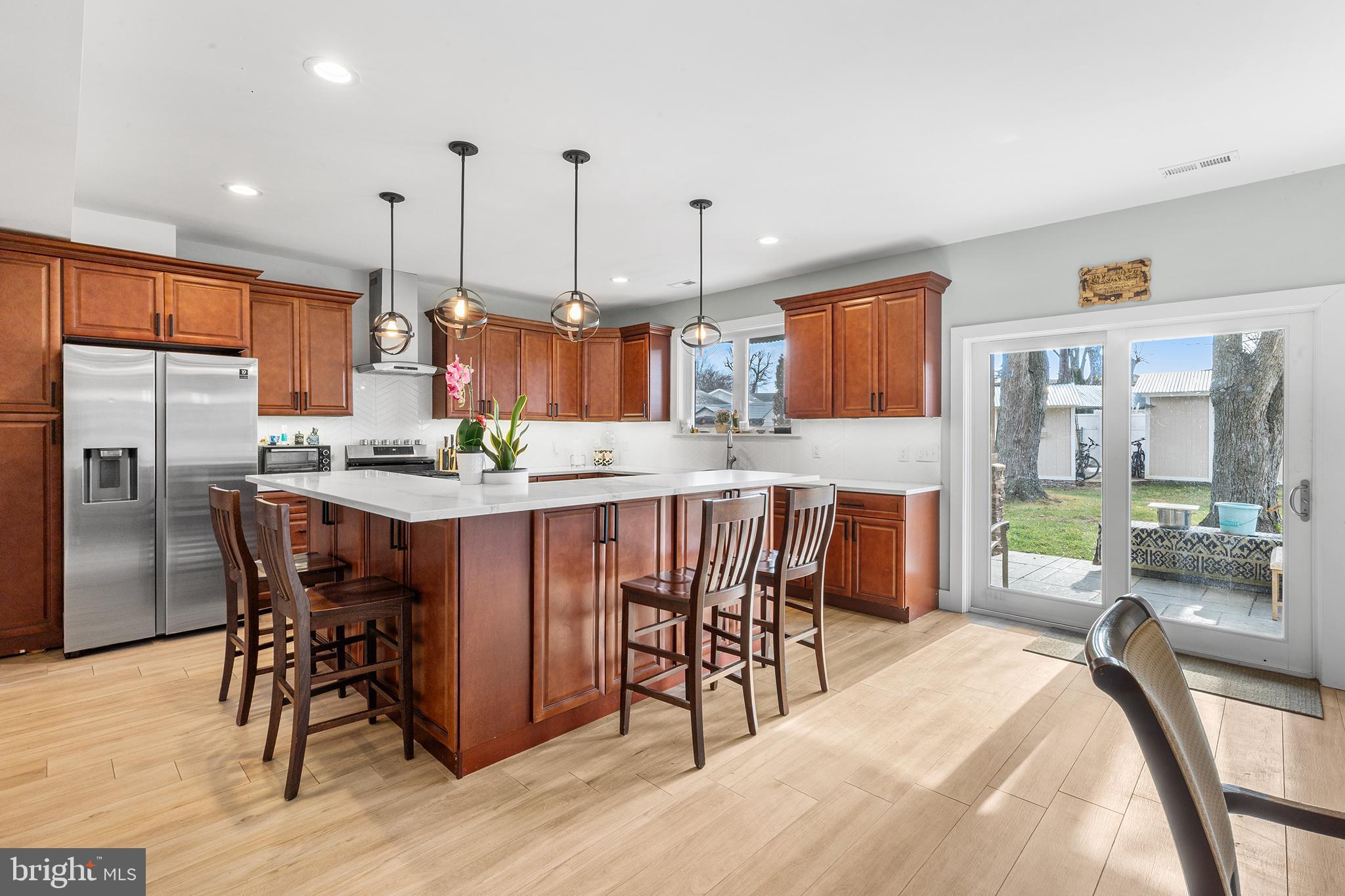 118 Blough Road Fairless Hills, PA 19030 - Photo 7 of 37 a kitchen with stainless steel appliances kitchen island granite countertop a table chairs and a refrigerator
