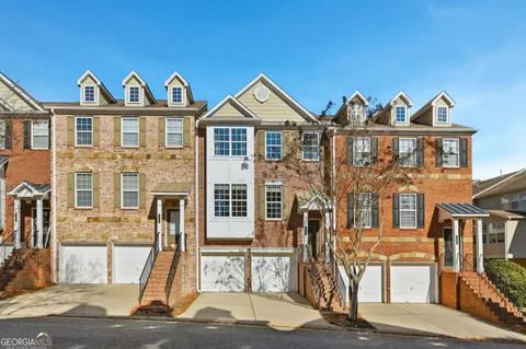 a view of a brick house with many windows