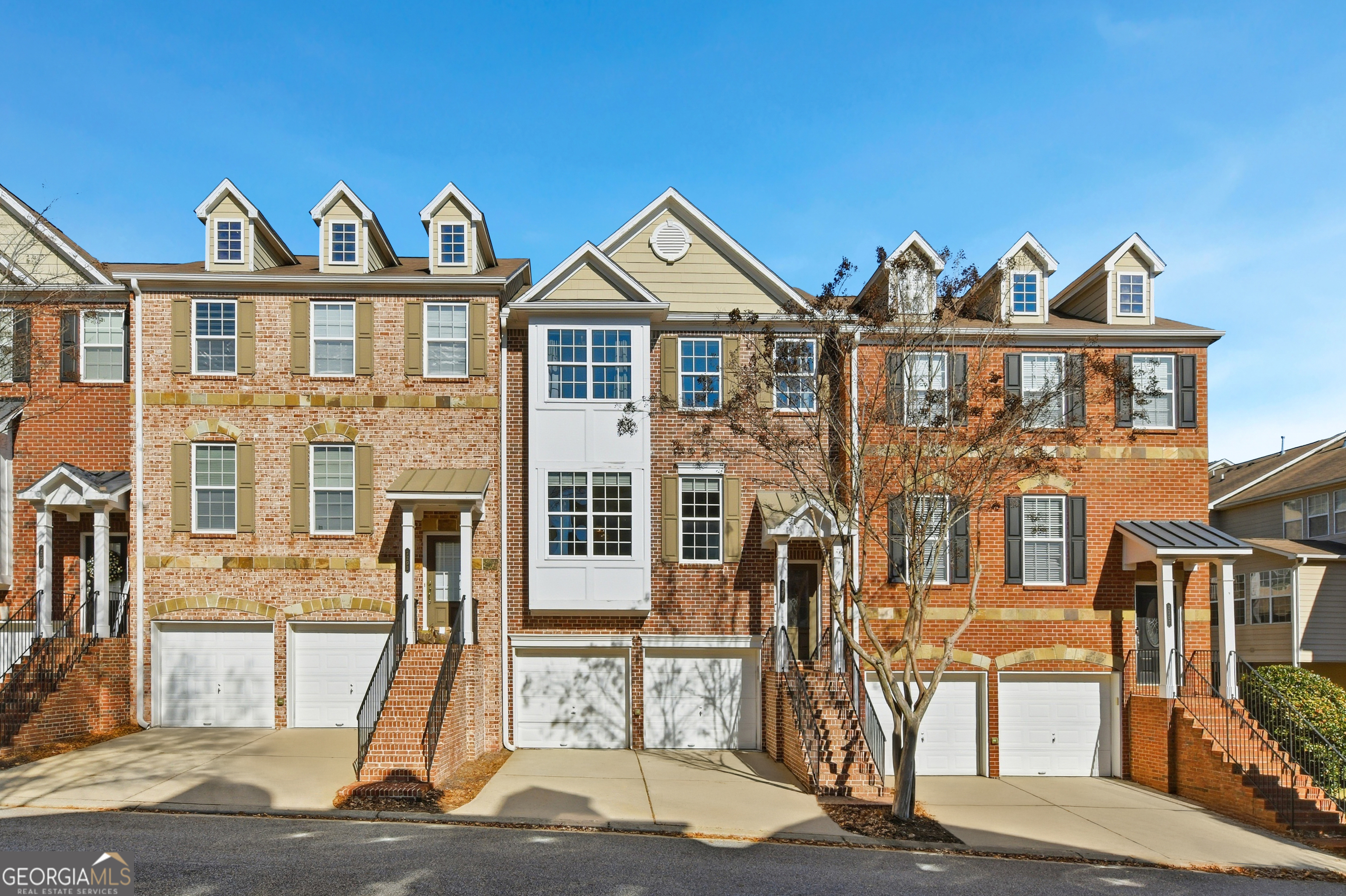 a view of a brick house with many windows