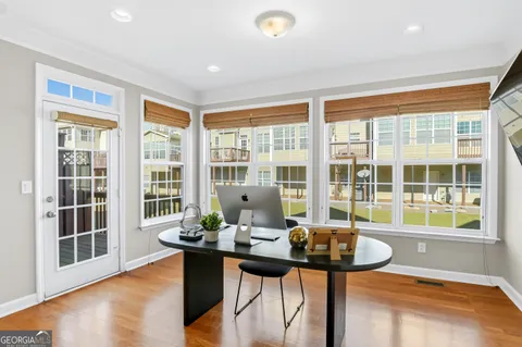 a view of a dining room with furniture window and wooden floor