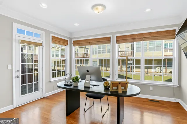 a view of a dining room with furniture window and wooden floor