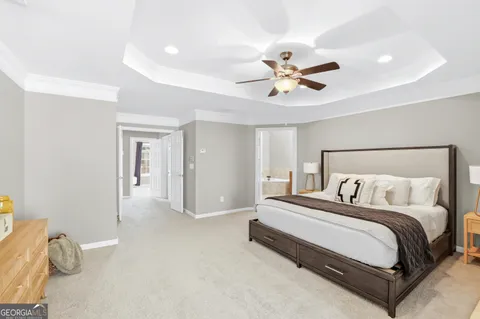 a bedroom with a bed and a ceiling fan