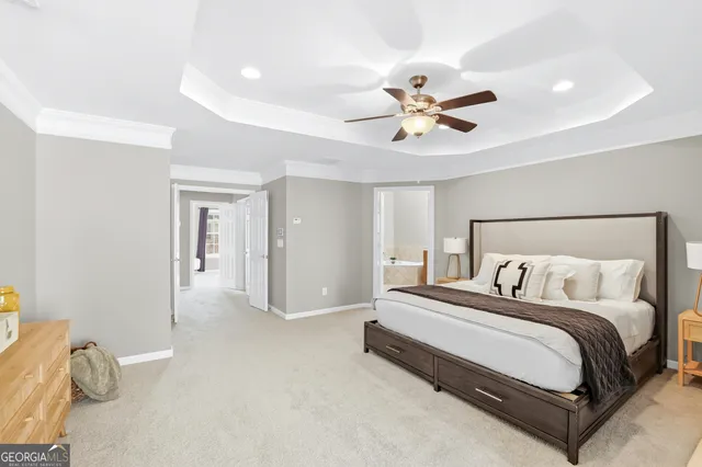 a bedroom with a bed and a ceiling fan