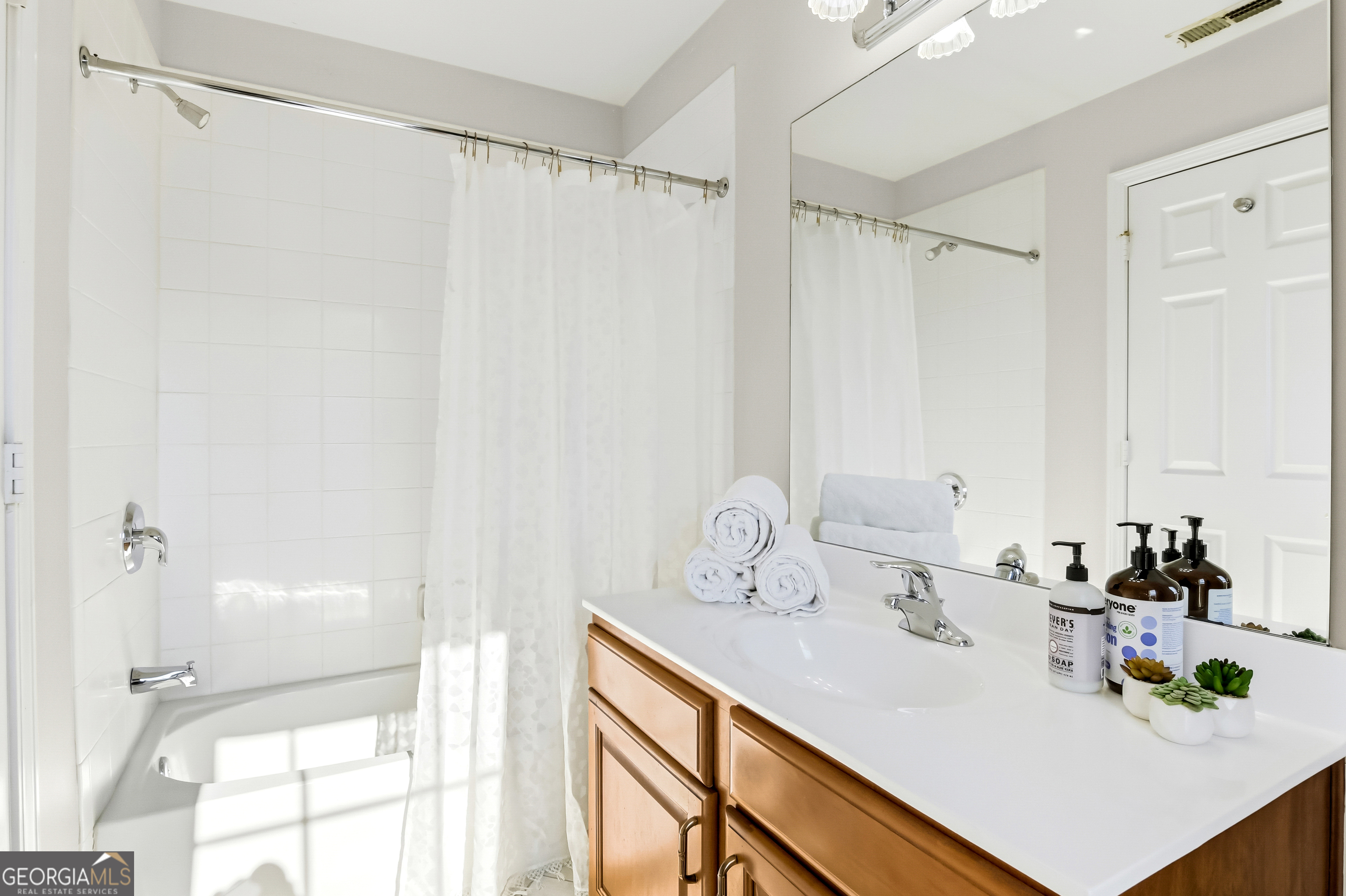 2205 Concordia Way Southeast, Unit 12 Smyrna, GA 30126 - Photo 20 of 25 a bathroom with a sink and a mirror