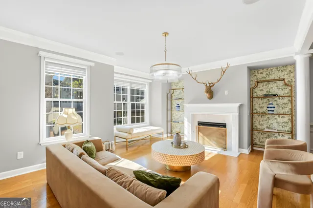 a living room with furniture fireplace and a large window