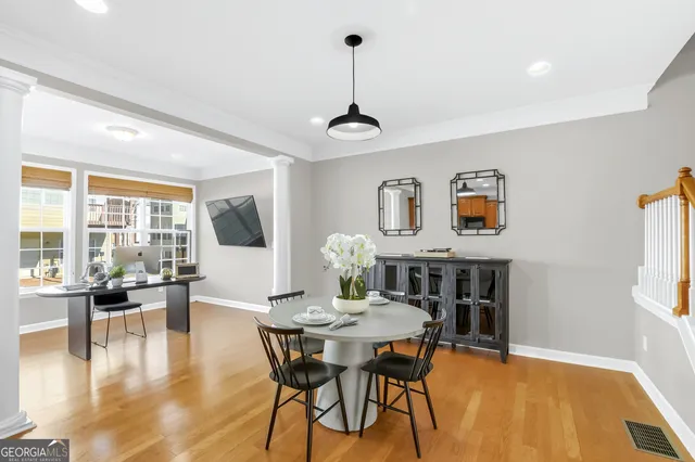 a view of a dining room with furniture and wooden floor