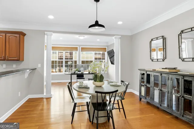 a dining room with furniture a chandelier and wooden floor