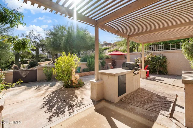 a view of a patio with couches table and chairs potted plants