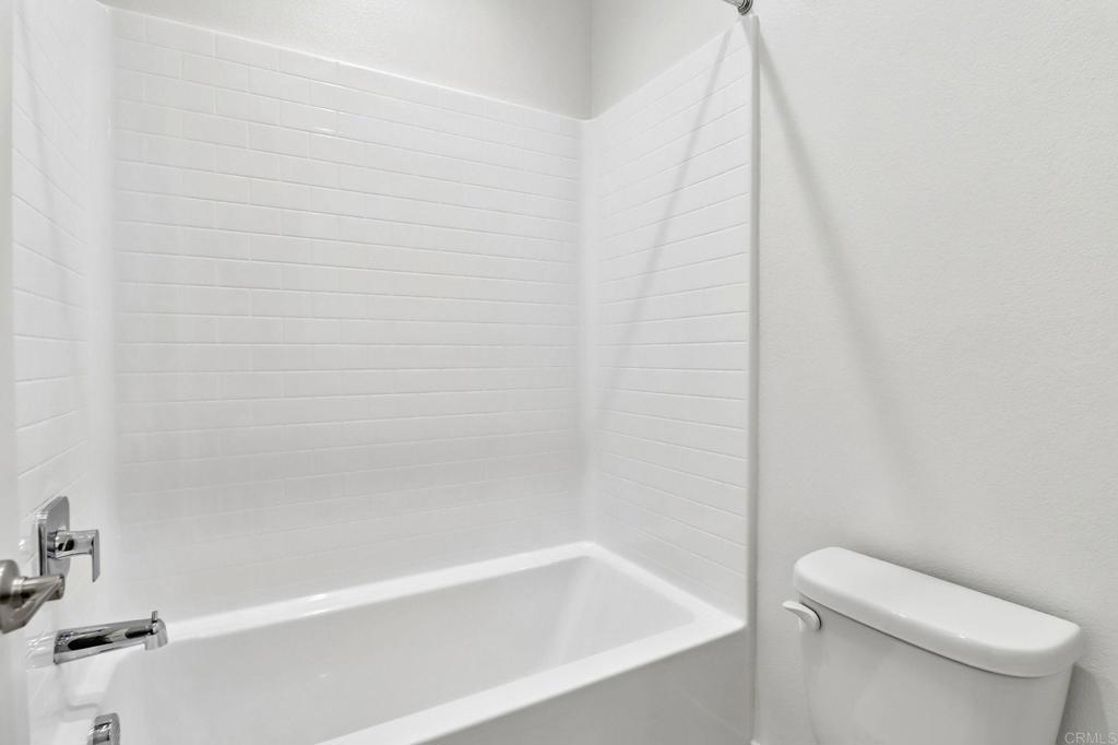 3521 Butler Place Escondido, CA 92027 - Photo 36 of 50 a white bath tub sitting next to a white toilet and vanity