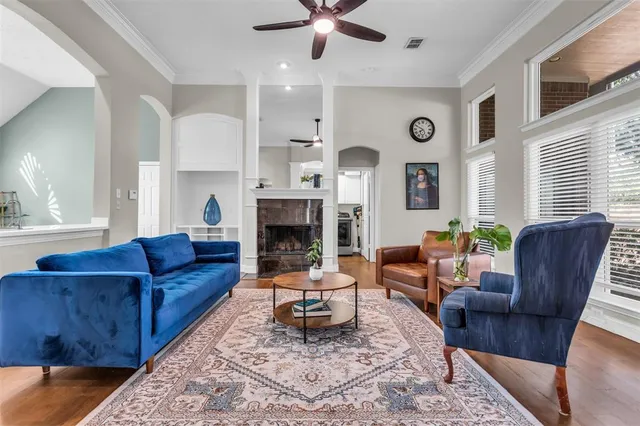 a living room with furniture fireplace and a window