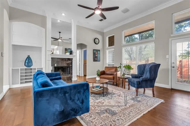 a living room with furniture fireplace and window