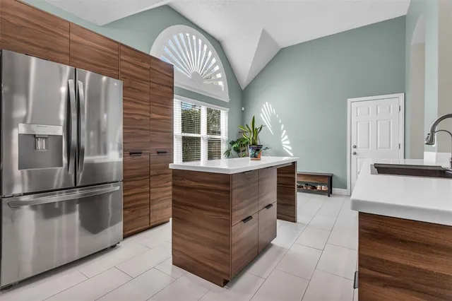 a kitchen with stainless steel appliances granite countertop a refrigerator and a stove