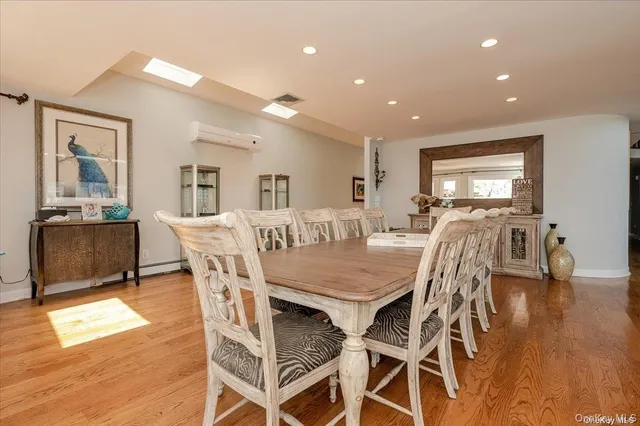 a dining area with stainless steel appliances kitchen island granite countertop a dining table and chairs