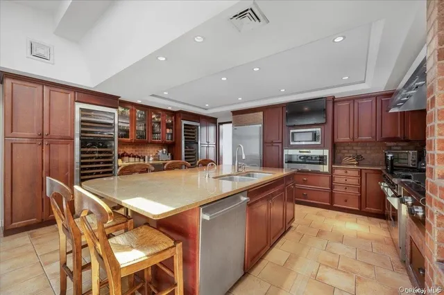a kitchen with stainless steel appliances granite countertop a sink stove and cabinets