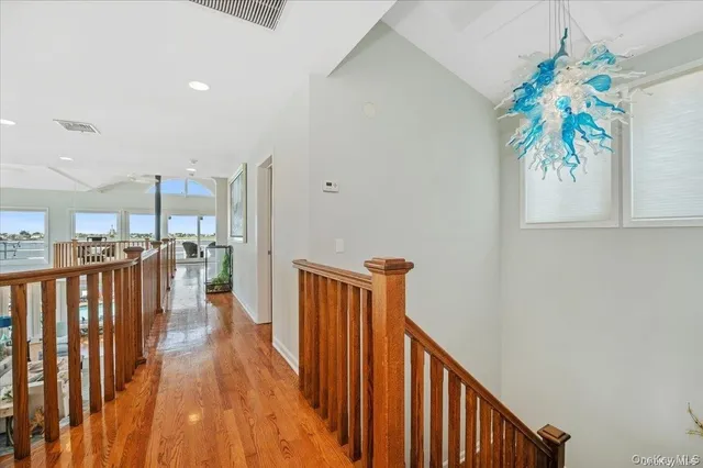 a living room with furniture kitchen view and a large window