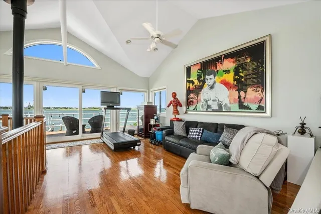 a living room with furniture a flat screen tv and a rug